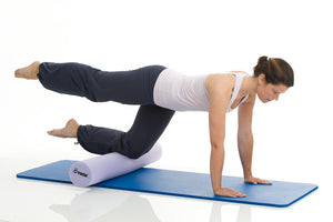 Woman exercising on TOGU Pilates Foam Roller Premium