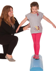 Young girl walking on airex balance beam