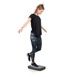 Girl balancing on Airex Balance pad mini